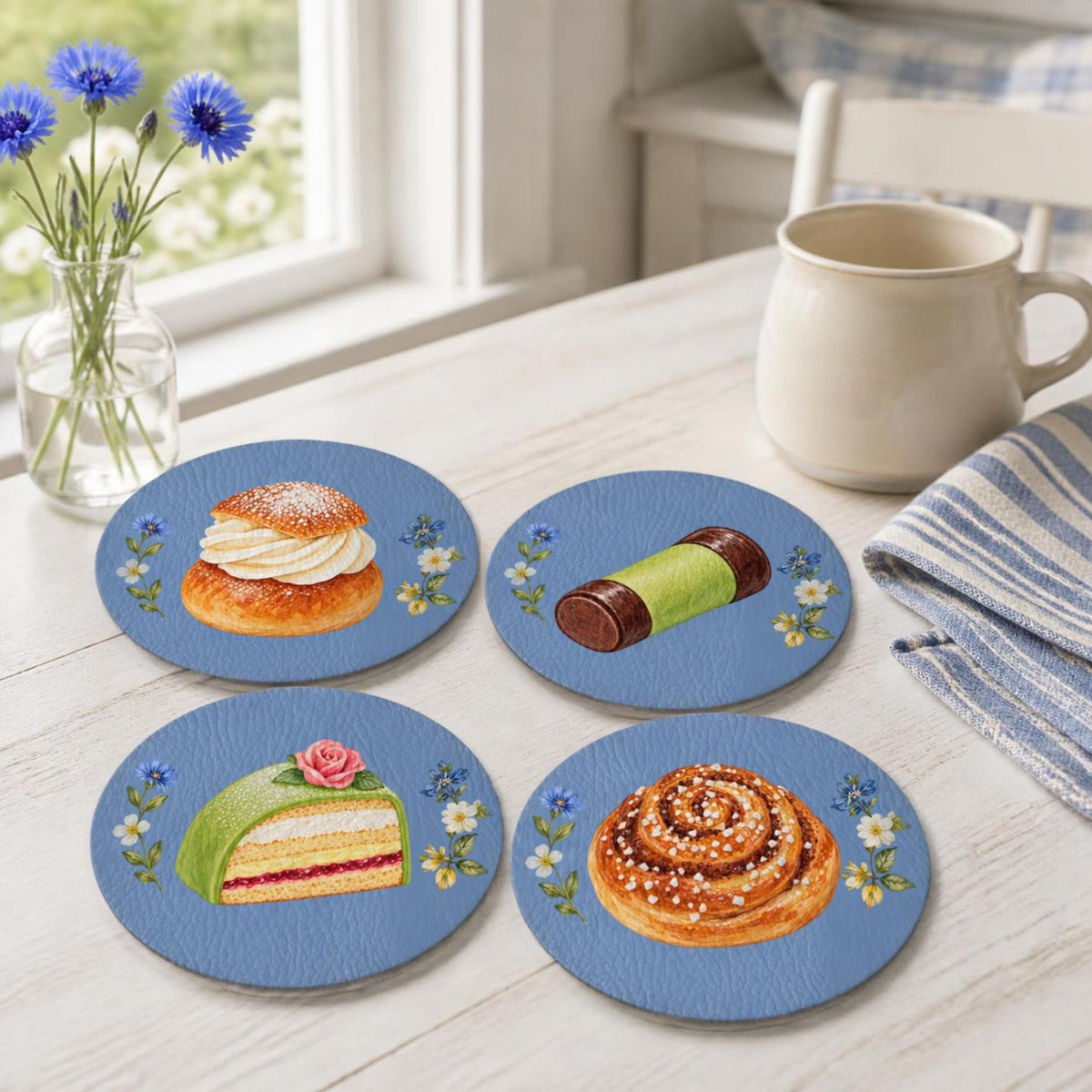 Set of four Swedish Blue fika coasters with kanelbulle, semla, prinsesstårta and dammsugare illustrations by Hej Hemma